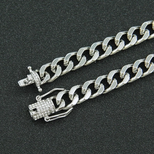Close-up of silver curb chain with micro-paved rhinestone box clasp detail