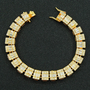 Macro detail of gold plated Cuban chain necklace with iced out crystals and box clasp