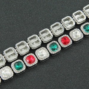 Macro detail of iced-out Cuban chain showing front colorful gems and back metal structure