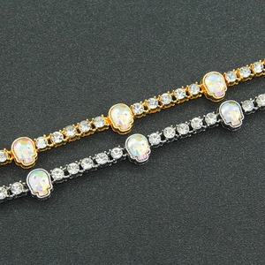 Hip hop skull bracelet with shimmering crystals and colorful pendants in gold and silver