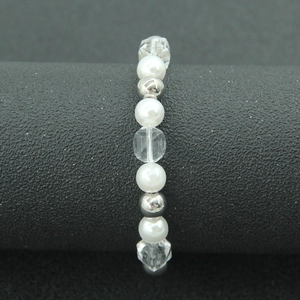 Elegant pearl and silver bead mixed strand bracelet on black cylindrical display