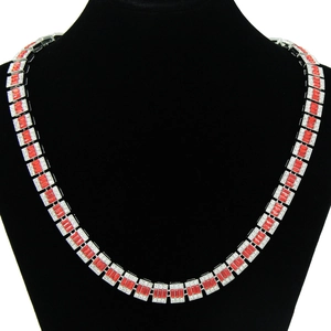 Detail of hip-hop cuban chain featuring red rectangular stones and micro-pave crystals