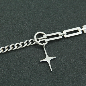 Detailed view of silver Cuban and paperclip chain necklace with North Star pendant