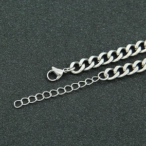 Macro detail of silver cuban chain with lobster clasp and adjustable link extension
