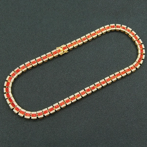 Hip hop iced out Cuban chain necklace with red gemstones and gold finish in flat layout