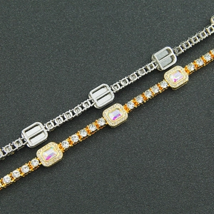 Macro view of iced out Cuban link chain with colorful CZ stones and gold silver plating