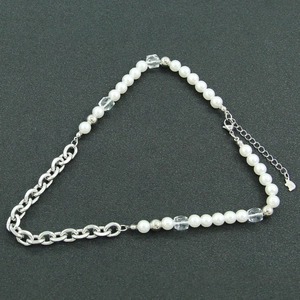 Detail of half pearl and metal chain hybrid bracelet with S925 silver clasp tag