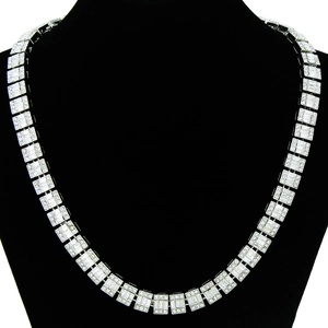 Detailed close-up of iced out Cuban link necklace with rectangular baguette crystals