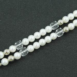 Chic titanium steel necklace with white pearls and faceted glass beads on gray background