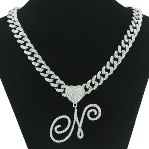 Iced out silver tone Cuban chain necklace with iced heart and large letter N pendant