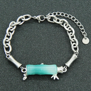 Unisex stainless steel chain bracelet with green resin bamboo pendant and leaf detail
