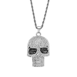 Hip-hop skull pendant necklace with sparkling crystals and silver twist chain on white backdrop