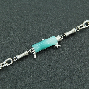 Bamboo style bracelet with green glass bead and silver titanium steel link chain