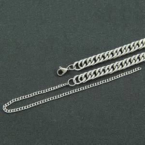 Detailed view of silver-tone polished curb chain necklace with secure lobster clasp closure