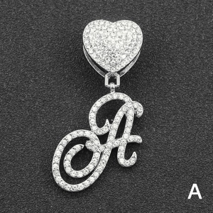 Macro view of iced out silver letter A pendant with heart clasp and clear rhinestones