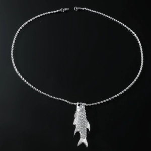 Detailed view of silver fish pendant with full crystal pavé on twisted rope chain