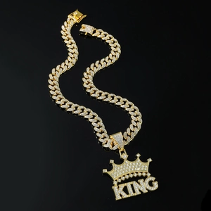 Hip hop style gold Cuban link necklace featuring a KING crown pendant with shimmering diamonds