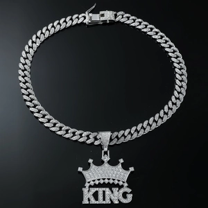 Macro shot of silver hip hop crown pendant with KING letters and iced out diamonds