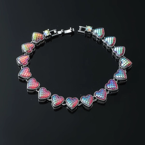 Exaggerated heart-shaped bracelet featuring iridescent mermaid scales and diamond accents