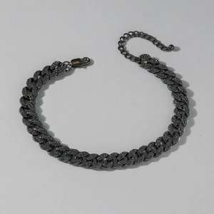 Close-up of gun black Cuban anklet with sparkling rhinestones and lobster clasp