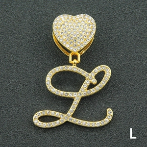 Close-up of gold heart clasp and iced out cursive letter L pendant with white crystals