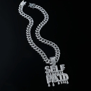 Silver Cuban link necklace with iced out SELF PAID dripping letter pendant in hip hop style