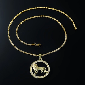Close-up of golden lion medallion necklace with iced-out crystals and rope chain