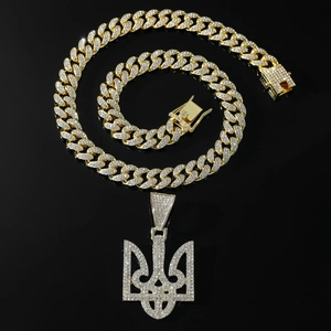 Gold hip-hop Cuban link chain with iced out Ukraine trident pendant on black background