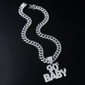 Detailed view of silver Cuban chain with iced-out 90's BABY pendant and white zircons