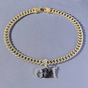 Détail de la chaîne cubaine dorée avec pendentif chat et accents de pierres noires