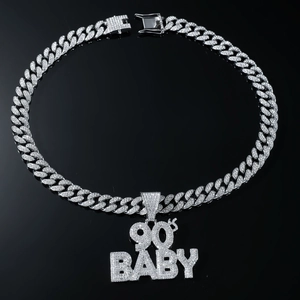Macro detail of iced-out 90'S BABY pendant on high-shine silver cuban link chain