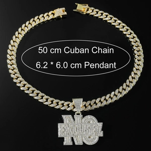 Close-up of gold iced out 'NO EXCUSES' pendant necklace with 50cm Cuban link chain