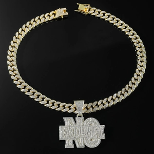 Close-up of iced out gold plated NO EXCUSES pendant and hip hop cuban link necklace