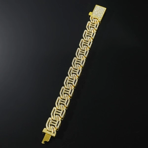 Macro shot of heavy gold plated hip hop Cuban link bracelet with full zircon paving