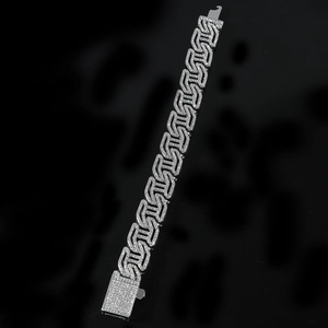 Macro view of iced-out silver Cuban link bracelet with a sparkling diamond box clasp