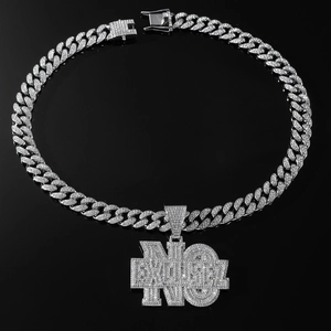 Close-up of iced-out Cuban chain and silver NO EXCUSES letter pendant with zircons