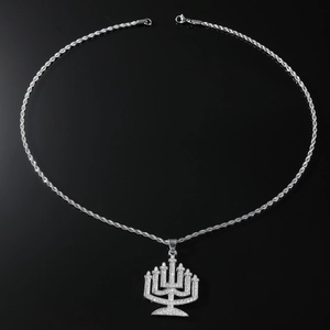 Close-up of hip hop Menorah pendant with iced-out crystals on a silver rope chain