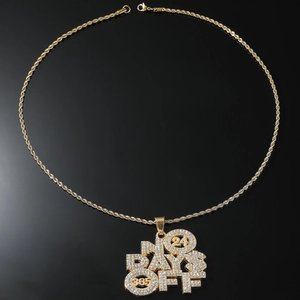 Detailed macro view of the NO DAYS OFF gold hip hop pendant with sparkling crystal stones