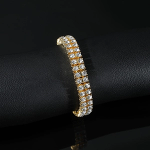 Men's gold double-row tennis bracelet with shimmering round crystals on black display