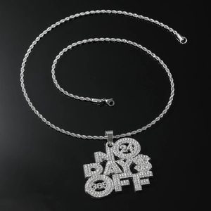 Macro shot of silver hip-hop necklace with iced out NO DAYS OFF pendant on rope chain