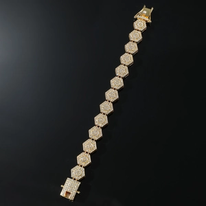 Macro shot of hip hop gold bracelet with rhombus links and iced out pavé crystal finish