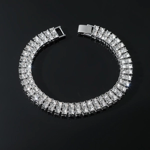 Iced-out double row rhinestone bracelet for men featuring a metallic clasp over a mirror base