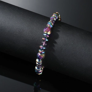 Iridescent magnetic hematite beaded bracelet on a professional black display stand