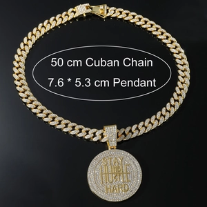 Detail view of iced-out gold pendant showing Stay Humble Hustle Hard engraving and 50cm chain