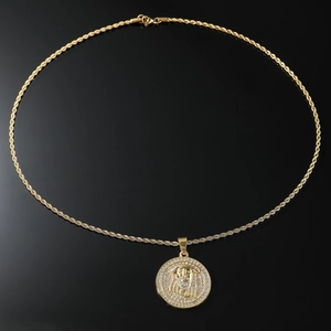 Macro shot of gold-plated rope chain with large iced-out Jesus piece portrait pendant
