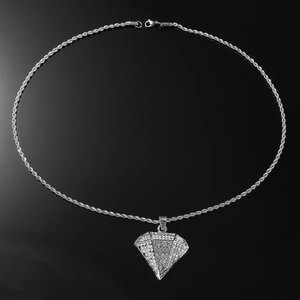 Macro detail of silver hip hop rope chain and sparkling full diamond triangle pendant