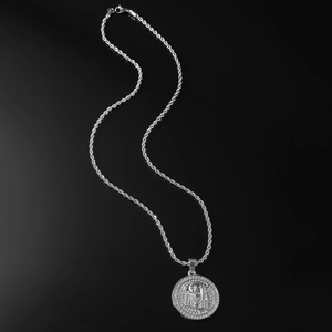 Close-up of silver rope chain necklace with iced-out Jesus portrait pendant on black glass