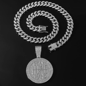 Detailed shot of iced-out Stay Humble Hustle Hard pendant on silver Cuban link chain