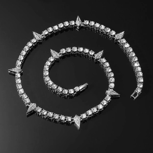 Macro view of silver Cuban chain necklace with water drop diamonds and sharp spike details