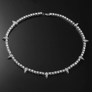 Detailed close-up of hip-hop silver tennis chain with triangular spike drop pendants